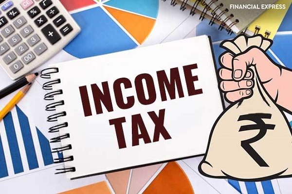 "Income Tax" text on paper sheet with magnifying glass on chart on wooden table - business, banking, finance and investment concept.